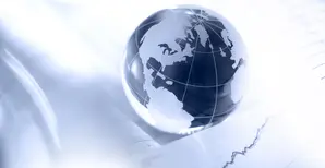 Glass globe and financial charts