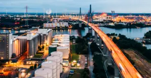 An illuminated power station, flyover and Hamburg docks