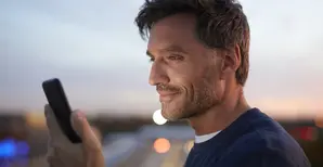Man 40s looking at his phone