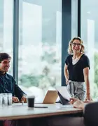 Group of people sitting around a table in an office