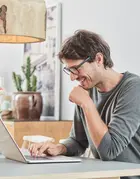 Man sitting at table with laptop