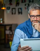 Older man looking at tablet thoughtfully
