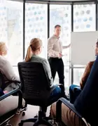 Group sitting in front of a whiteboard