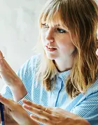 woman demonstrating something on the monitor