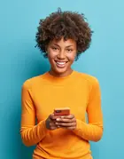 woman with mustard jumper smiling 