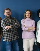 group of 4 people in front of a blue background