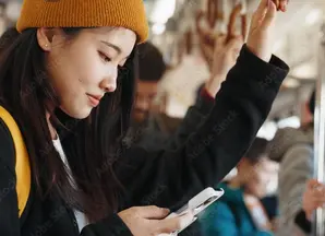 Woman reading phone on train