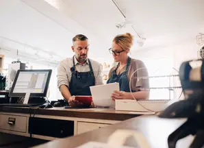 Two people working at a countertop