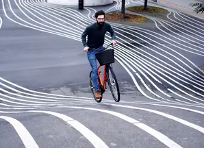 A man riding a bike in many tracks 