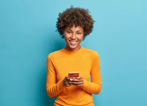 woman with mustard jumper smiling 