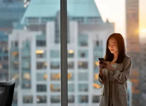woman at her office checking her phone