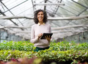 signora con table in un vivaio di piante