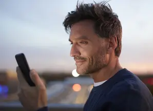 Man 40s looking at his phone