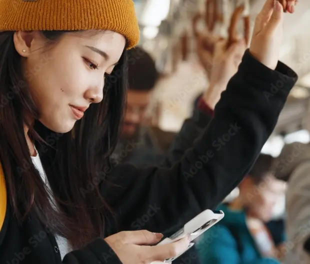 Woman reading phone on train