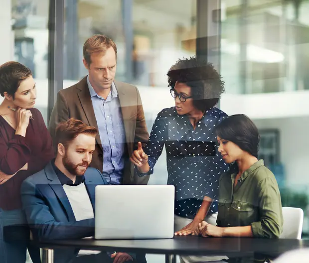 co-workers looking at a laptop