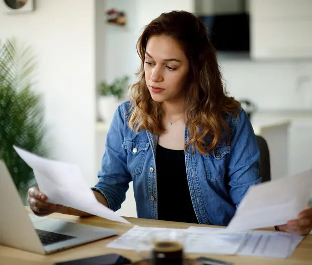 a girl reading documents at home