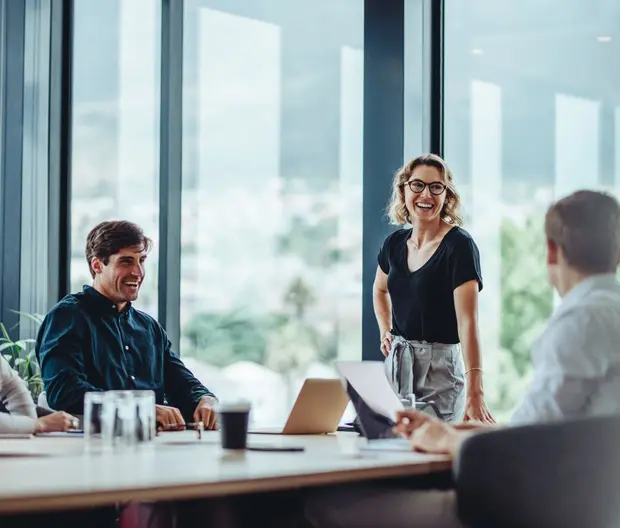 Group of people sitting around a table in an office