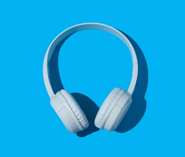 wireless white headphones on blue background