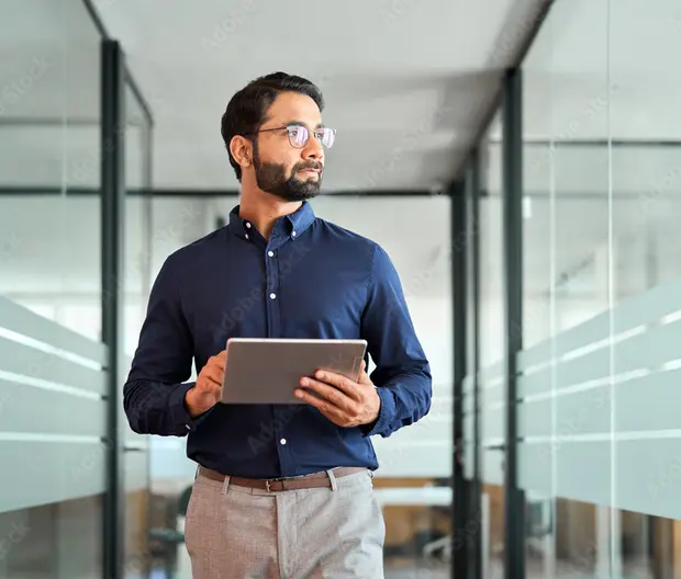 Young man with a tablet in the office corridor