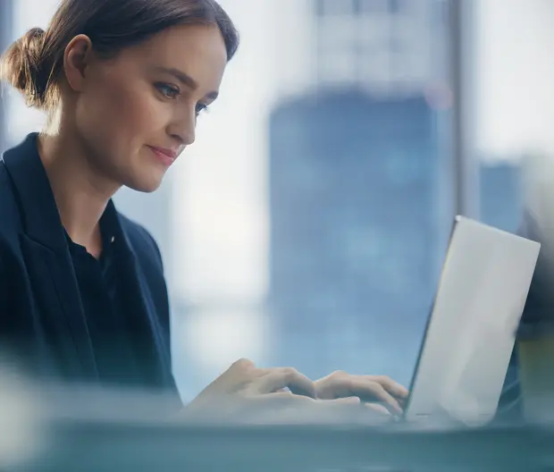 Woman working on a laptop in an office