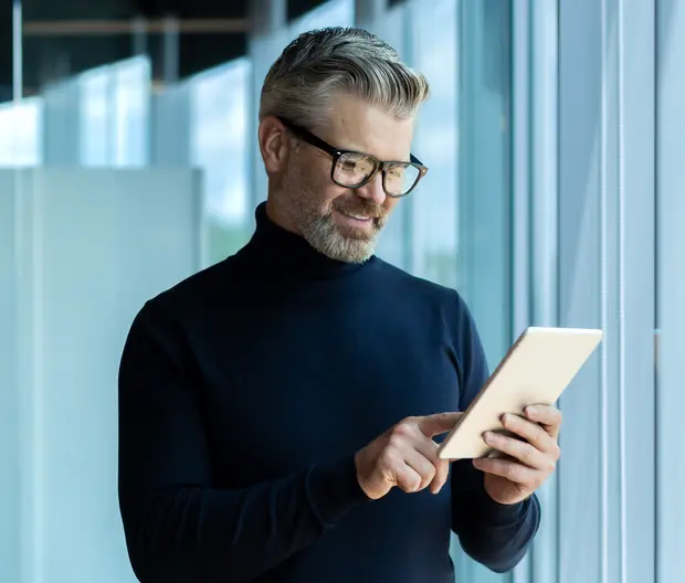Geschäftsmann liest News auf dem Tablet
