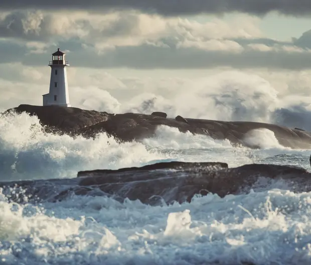 Lighthouse surrounded by surf