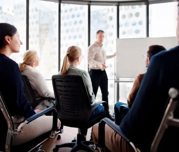 Group sitting in front of a whiteboard