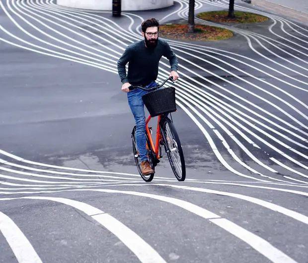 A man riding a bike in many tracks 