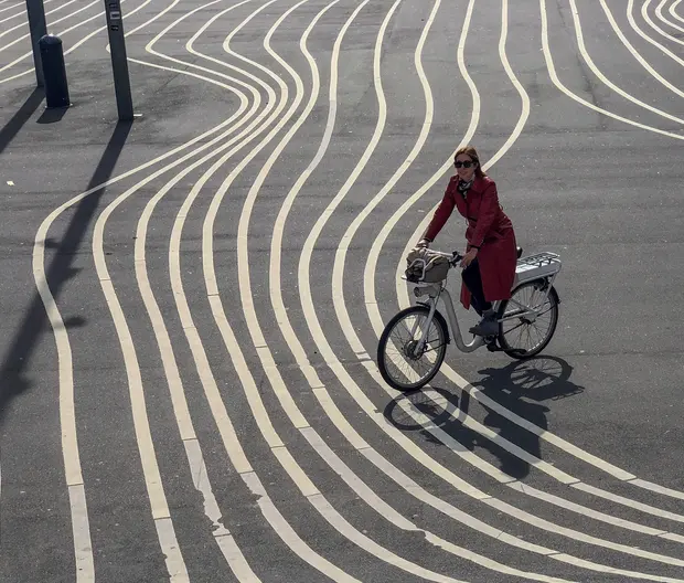 a woman riding a bike, choosing a track from many