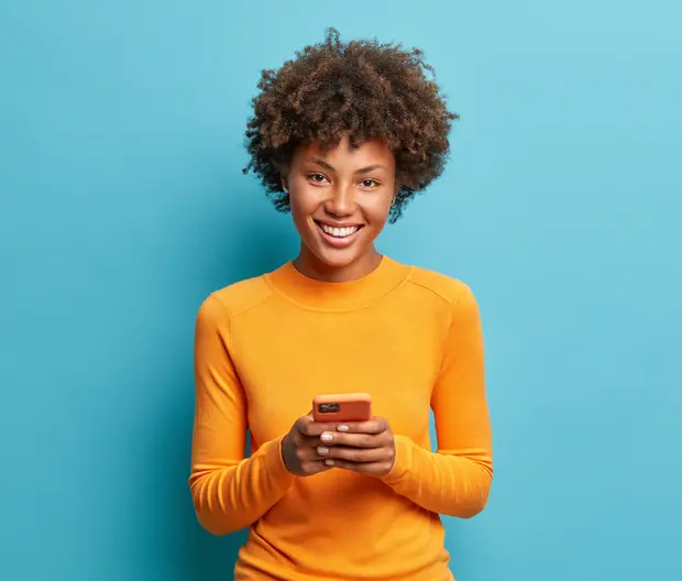 woman with mustard jumper smiling 