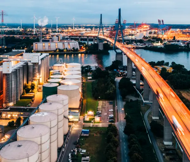 An illuminated power station, flyover and Hamburg docks