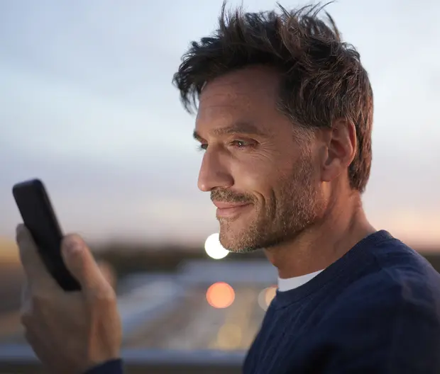 Man 40s looking at his phone