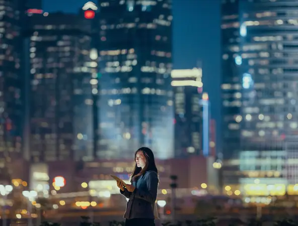 Woman in cityscape at night