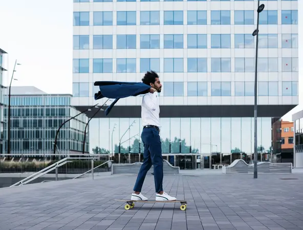 Man on skateboard with jacket over shoulder