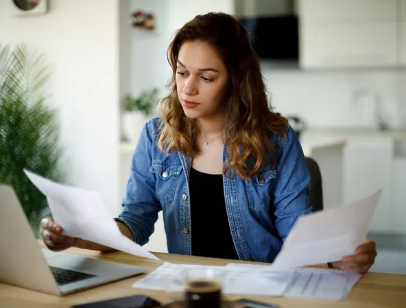 a girl reading documents at home