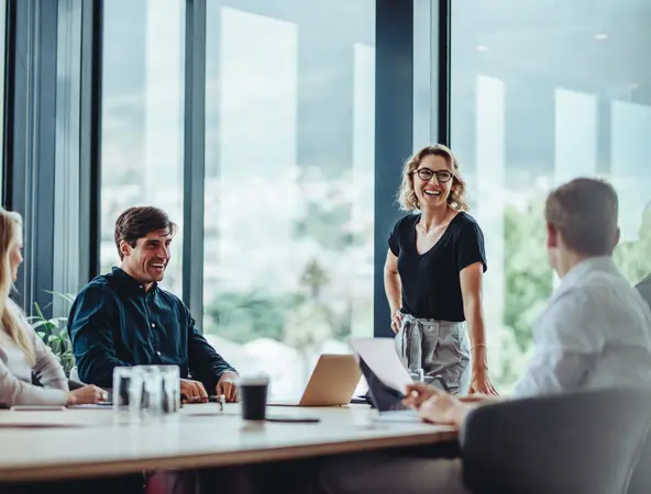 Group of people sitting around a table in an office