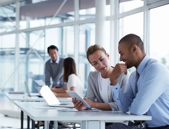 people looking at a tablet in office