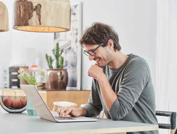Man sitting at table with laptop