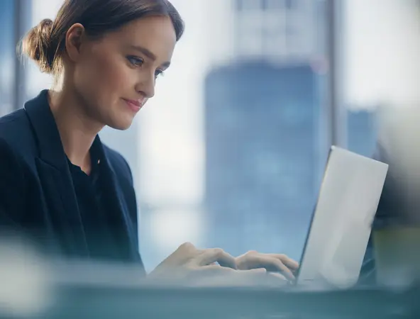 Woman working on a laptop in an office