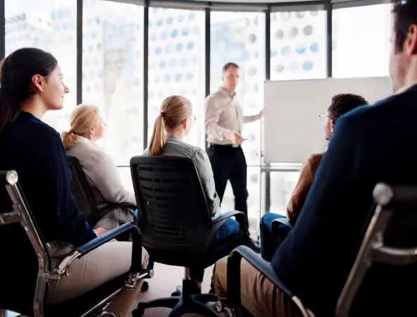 Group sitting in front of a whiteboard