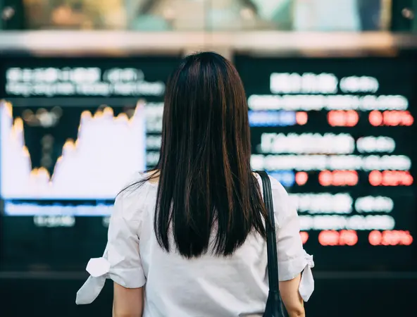 a woman looking at the stock exchange market