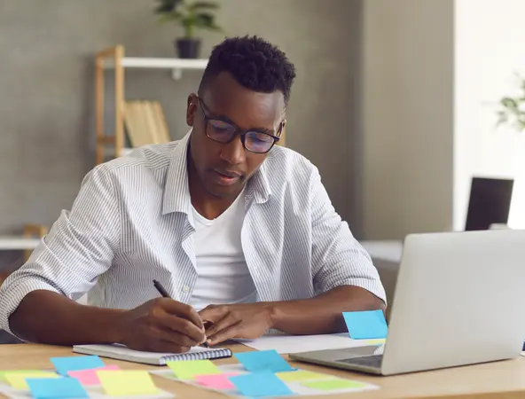 man writing in a notebook 