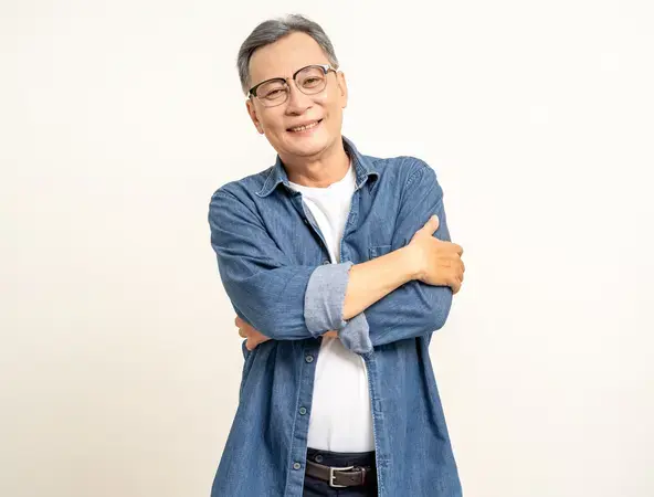 Happy asian mature old man arms crossed glasses