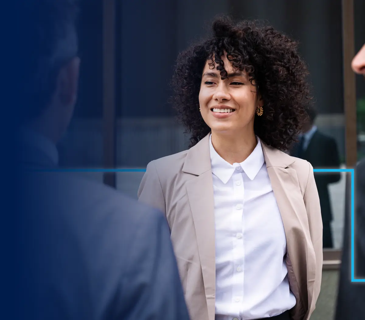 A woman in a suit engages in conversation with two men in Amundi offices.