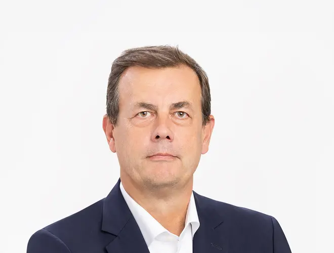 Professional asset manager in formal attire, set against a plain background.
