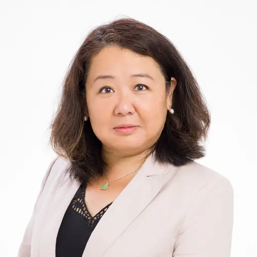 Asset manager in a light-colored blazer, set against a plain white background.