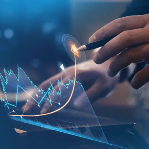 A financial expert analyzes market trends with a tablet in the Amundi offices.