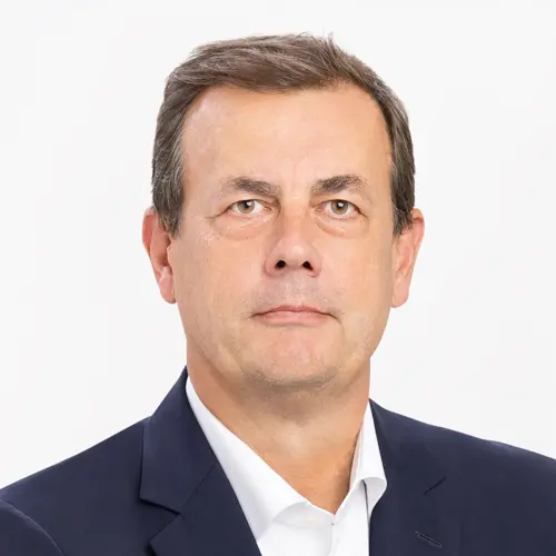 Professional asset manager in the Amundi offices, wearing a dark suit and white shirt.