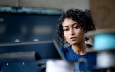 Woman checking her phone at the office