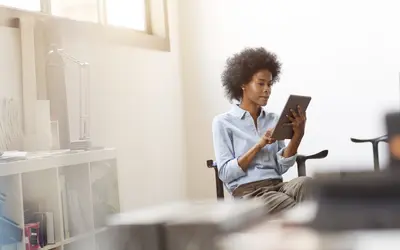A financial expert reviewing data on a tablet in the Amundi offices.